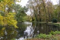 A small lake surrounded by trees in autumn colors near Linschoten Royalty Free Stock Photo