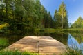 Small lake with a wooden pier in the Belgium Ardennes and Eifel park of the province of Liege near Bayehon. Royalty Free Stock Photo