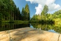 Small lake with a wooden pier in the Belgium Ardennes and Eifel park of the province of Liege near Bayehon. Royalty Free Stock Photo