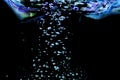 Small and large air bubbles in water on a black background, the concept of natural water resources, ecology, save nature