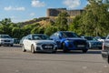 Small and large Audi car at a parking lot..