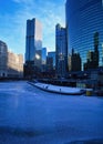 High-angle view of pedestrians on the riverwalk alongside a frozen Chicago River on a blue, frigid morning in winter. Royalty Free Stock Photo