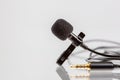 Small lavalier microphone or lapel mic with clip on white background Royalty Free Stock Photo