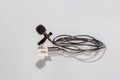 Small lavalier microphone or lapel mic with clip on white background. Royalty Free Stock Photo