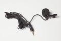 Small lavalier microphone on white background