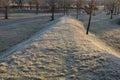 Small lawns are illuminated by January sun very low above horizon. wavy terrain models are seen and the roads are curved in curves Royalty Free Stock Photo