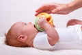 Small laying baby with toy