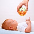 Small laying baby with toy