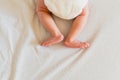 Small legs and feet of newborn baby on his bed Royalty Free Stock Photo