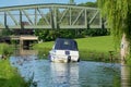 Leisure boat passing under walk bridge on the Lancaster Canal