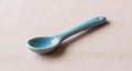 A small, light blue ceramic spoon Royalty Free Stock Photo