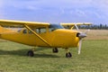 Small and Light Yellow Piper Aircraft near to the Runaway Ready to Take Off Royalty Free Stock Photo