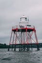 A small lighthouse in the middle of the water on the coastline of Cobh, county Cork