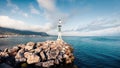 Small lighthouse in the port of Kamena Vourla town. Foggy spring morning on the Aegean Sea. Picturesque outdoor scene in Greece. Royalty Free Stock Photo