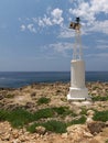 Small lighthouse on rocky coast Royalty Free Stock Photo