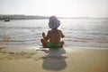 Small little child  kid boy running to the sea lake ocean beach at evening sunset looking far away Royalty Free Stock Photo