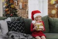 Small little girl in red dress holding Christmas or New Year gift box present Royalty Free Stock Photo