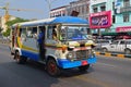 Small little mini bus cruising on the road in Yangon, Myanmar