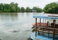Small local ferry boat docking along the river,