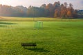 Small, local football pitch.Football gates placed on the grass. Beautiful, foggy, autumn morning in the countryside. Colorful Royalty Free Stock Photo