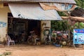 Small local motorbike workshop, Khmer man working with damaged motorbike