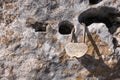 Small lock as symbol of eternal love hangs locked on rock. Details of Spain