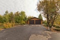 Small log cabin with 2 car garage built away from city in forest Royalty Free Stock Photo