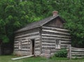 Small log cabin in the trees. Royalty Free Stock Photo