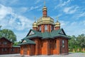 Small log church with three gilded domes Royalty Free Stock Photo