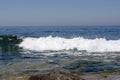 Small lonely wave breaks in the calm sea