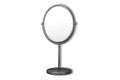 Small makeup mirror in oval frame on stand.