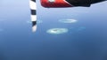 Multiple small islands with coral reefs captured from the seaplane, Maldives