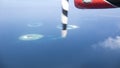 Multiple small islands with coral reefs captured from the seaplane, Maldives