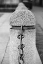 Marble pillar with chain. Black and white photo