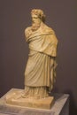 Small marble statue of god Dionysus with a wreath of ivy and pine nuts on the head