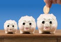 Small medium and large piggy banks on shelf Royalty Free Stock Photo