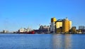 Red small cargo ship being loaded in a harbor Royalty Free Stock Photo