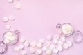 Small Meringue and Flass Jars with Small Meringues on Pink Background Flat Lay Top View Copy Space