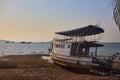 Small metal boat lies in the sand as a result of low tide in the early morning Royalty Free Stock Photo