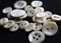 Small metal buttons with four holes. Shirt buttons.