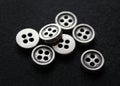 Small metal buttons with four holes. Shirt buttons.