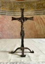 Small metal crucifix on the main altar of the Church of Saint John the Baptist in Varenna on lake Como.