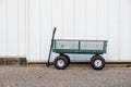 Small metal gardening cart in font of the farm house