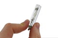 Small metal halide light bulb with GU10 10 mm mount held in right index finger and thumb