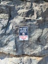 Sign on rock wall face Do Not Climb Rocks Stay On Trail