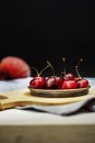 A small metal saucer filled with ripe cherries Royalty Free Stock Photo
