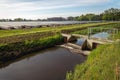 Small metal weir in a Dutch polder ditch Royalty Free Stock Photo