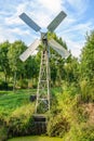 Small metal windmill controls the water level in the ditch.