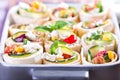 Small Mexican tortilla rolls filled with minced meat with beans, feta, zucchini and paprika, crispy baked Royalty Free Stock Photo