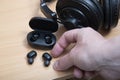 Small micro headphones are lying on the computer desk table